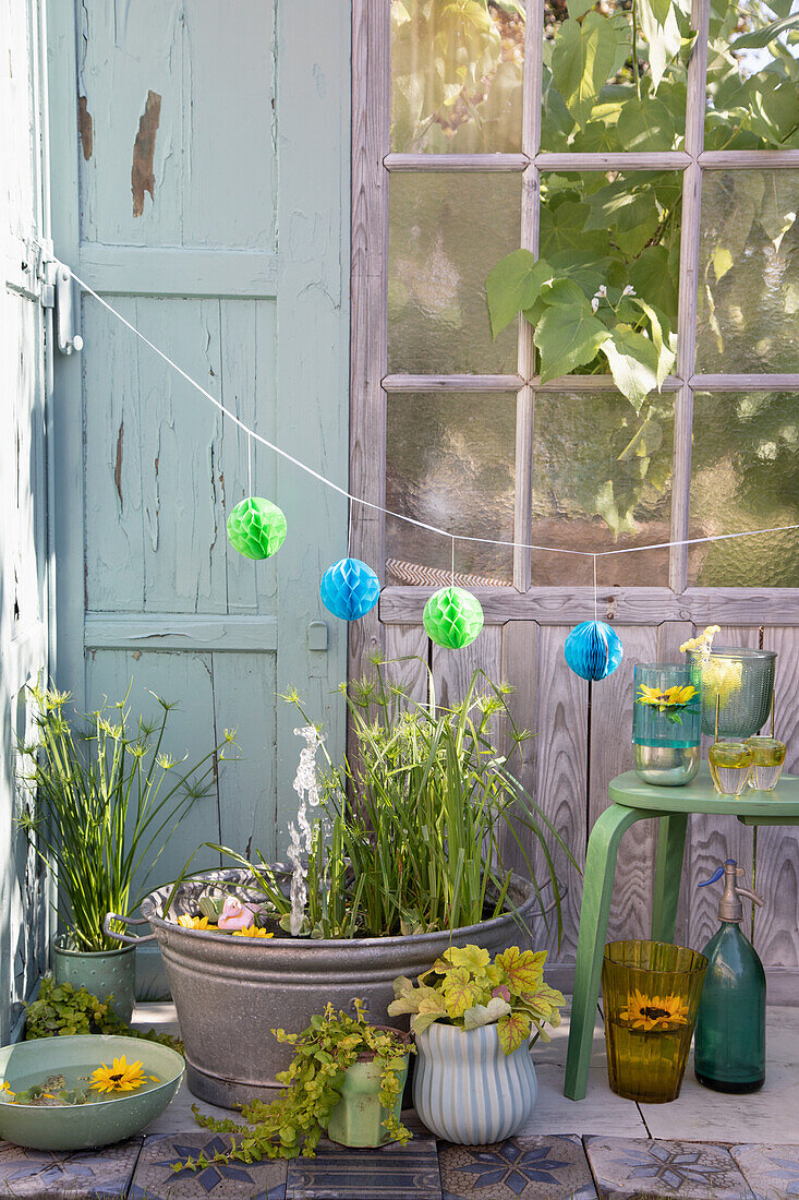 Idyllic water garden with plants and lanterns outdoors