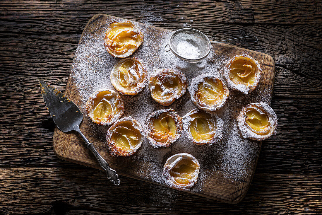 Mini puff pastry apple tartlets with icing sugar
