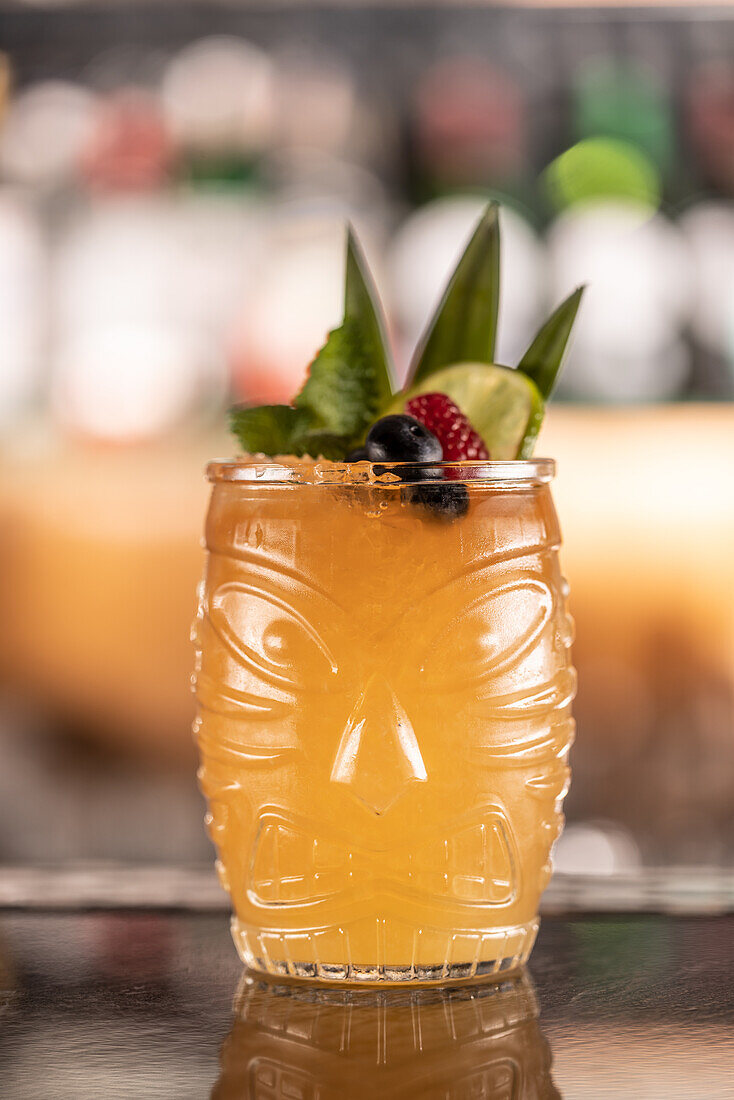 Mai Tai cocktail garnished with pineapple and blueberries