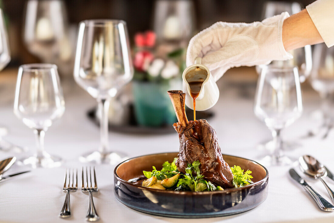 Leg of lamb on mashed potatoes with kale, demi-glace and herbs