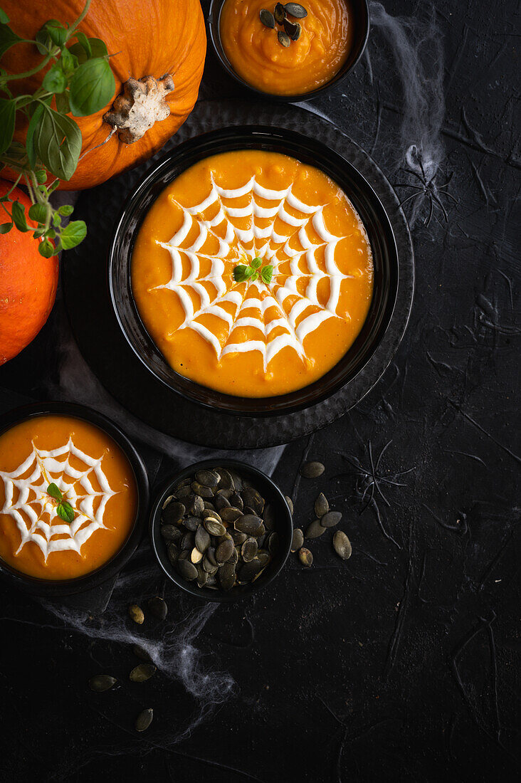 Creamy pumpkin soup with sour cream for Halloween