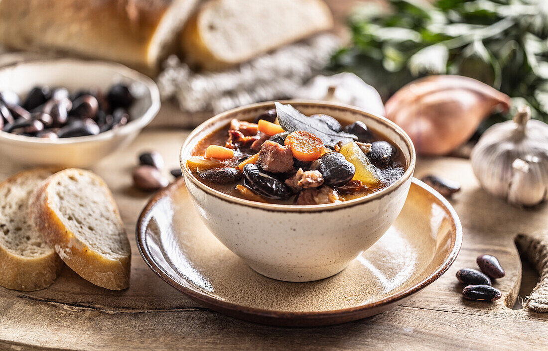 Traditional bean soup with large beans, smoked meat, potatoes and carrots