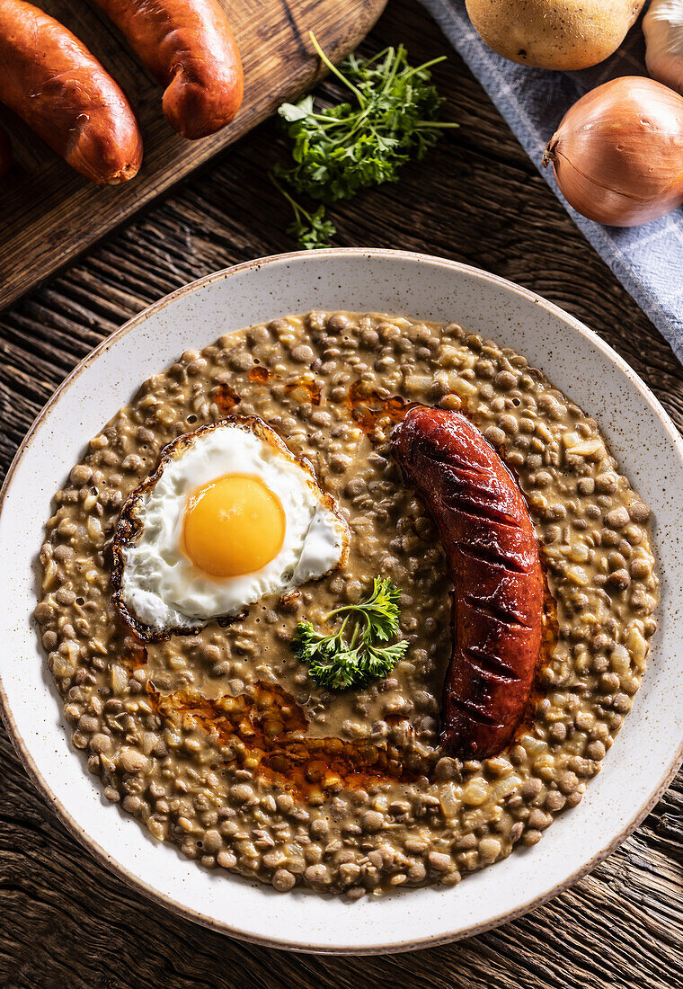 Lentil and potato stew with sausage and egg