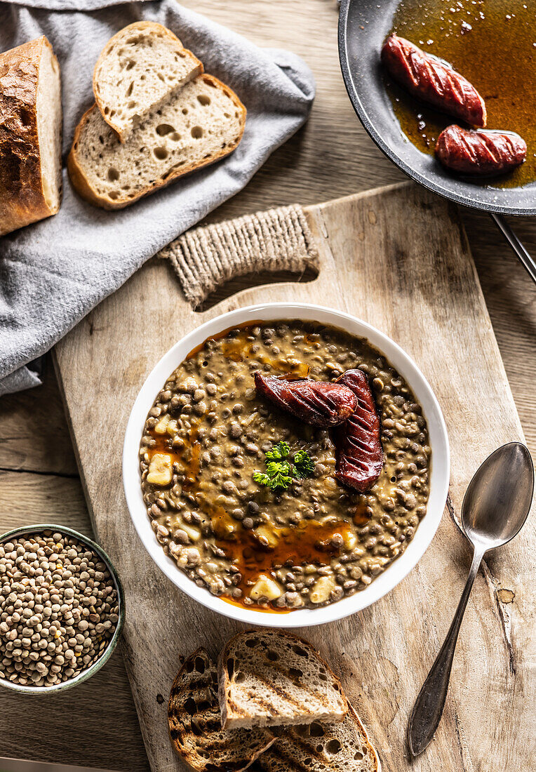 Lentil and potato stew with sausage and bread