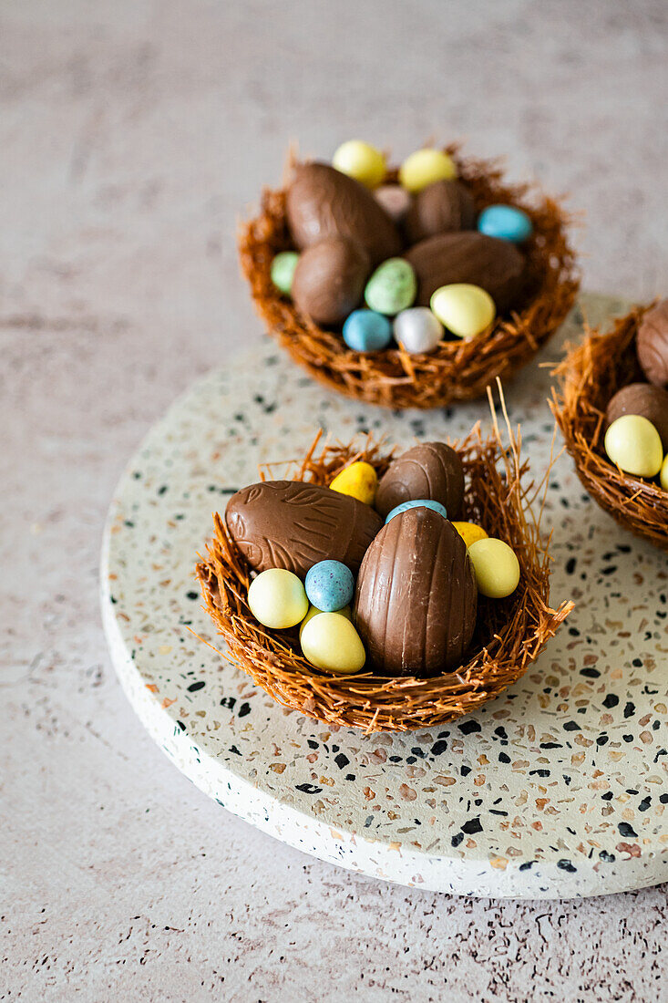 Easter nest made from vermicelli and melted chocolate filled with Easter eggs