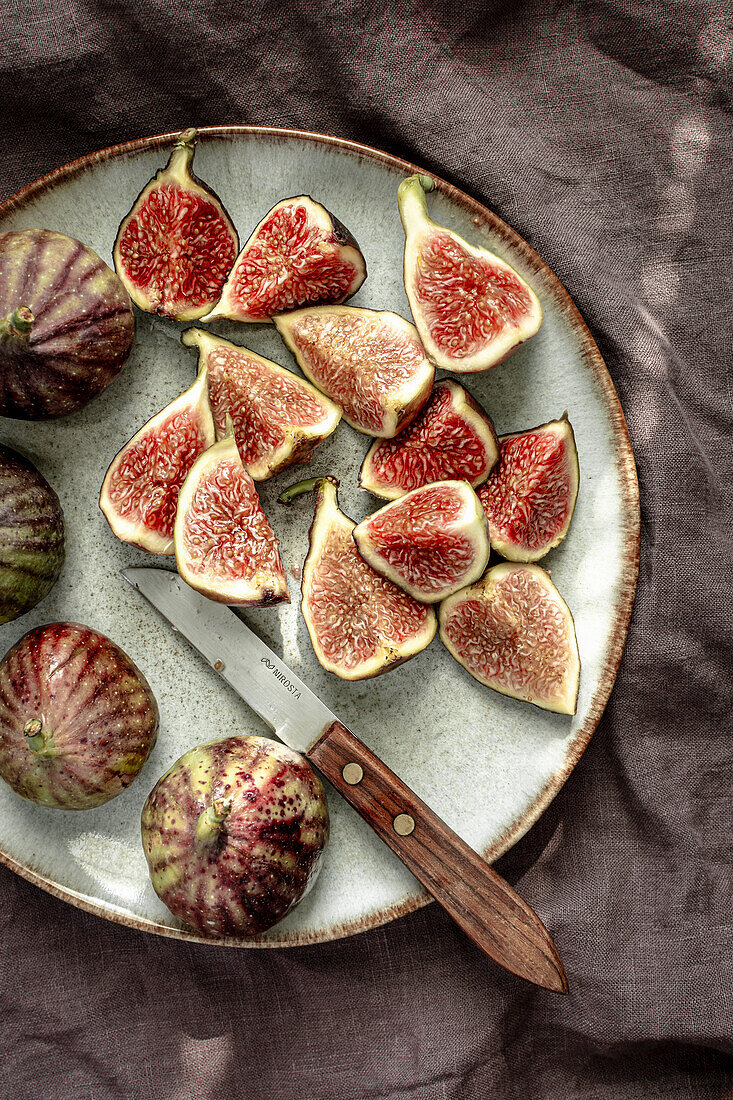 Whole and sliced fresh figs on a plate