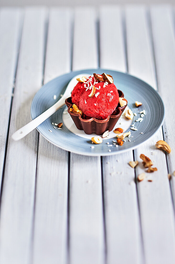 Frozen fruit ice cream in homemade chocolate cup