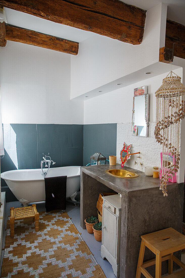 Boho-style bathroom with freestanding bathtub and macramé decoration