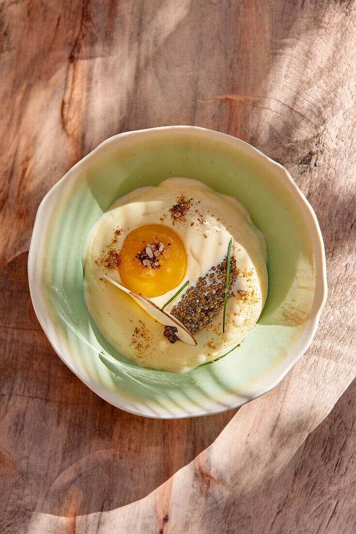 Cream of potato soup with caviar and egg