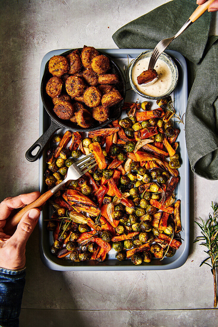 Sweet potato and Brussels sprout traybake with falafal and garlic sauce