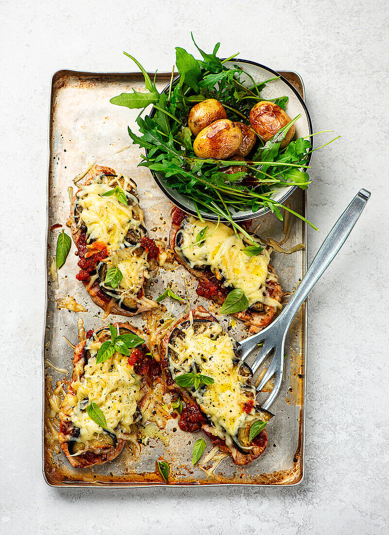 Parmigiana pork schnitzel with roast potatoes and rocket salad