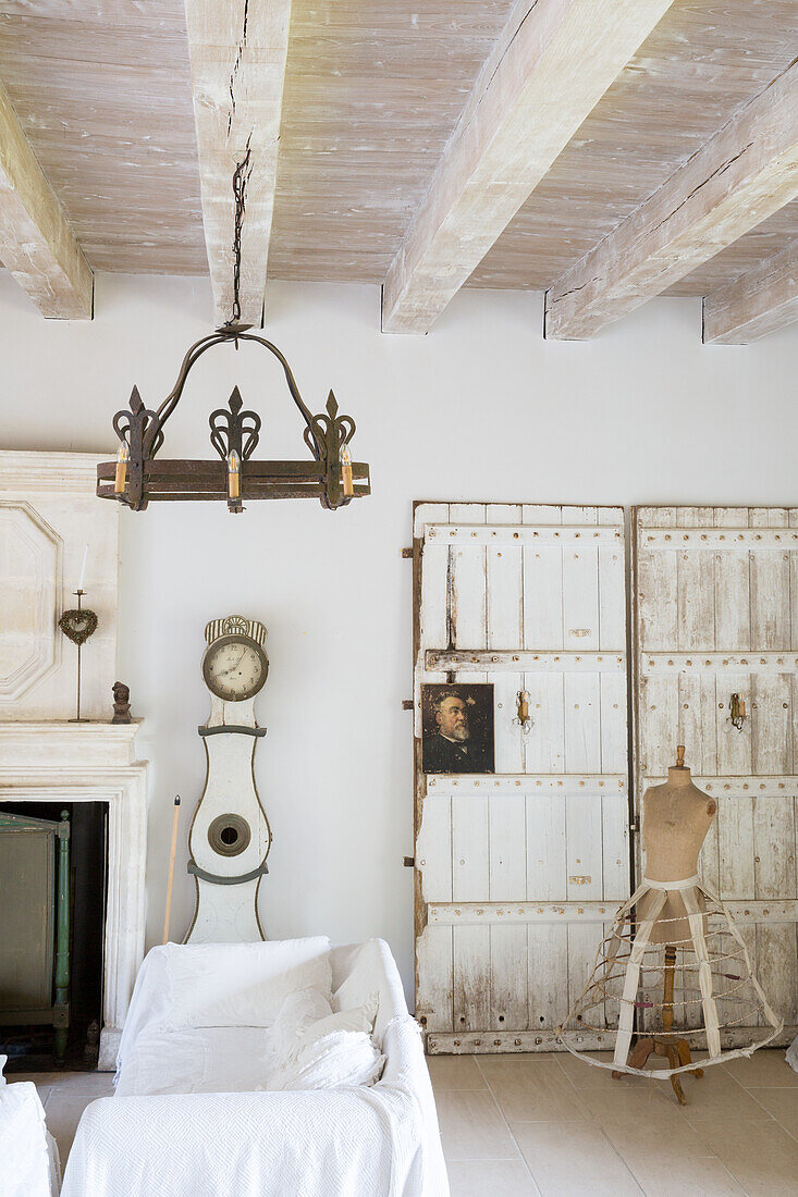 Living room in shabby chic style with antique grandfather clock and dressmaker's dummy