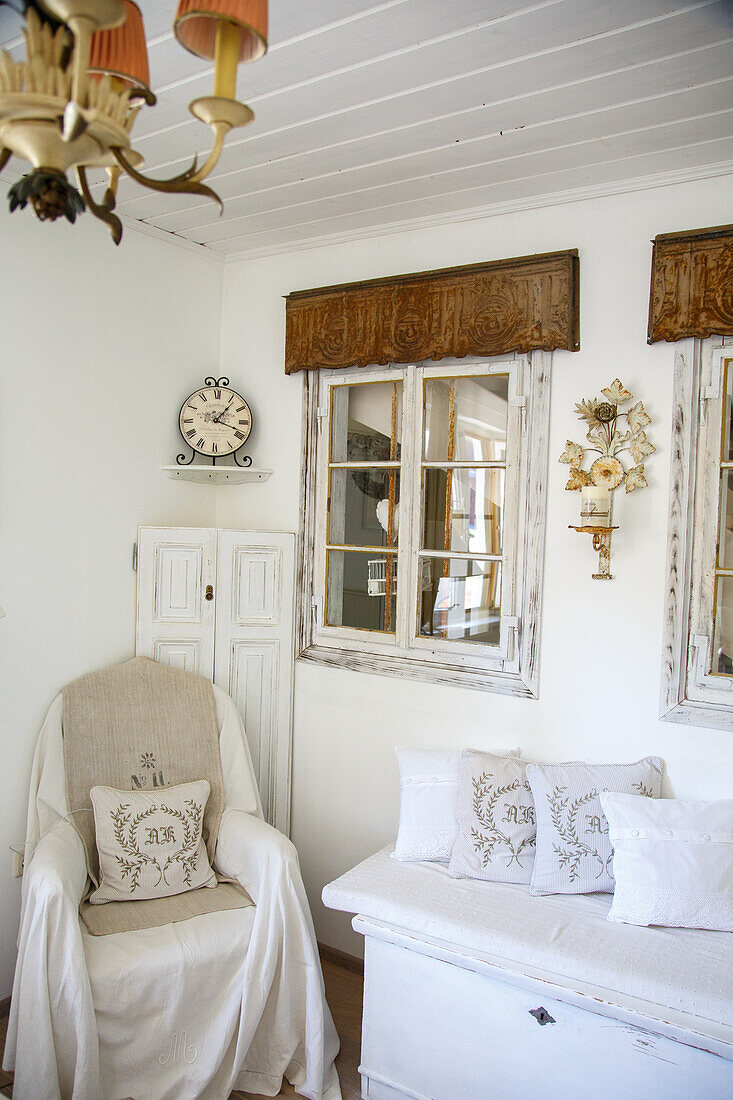 Country-style living room with white wooden furniture and antique clock