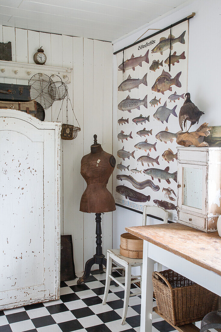 Nostalgic study with chessboard floor, dressmaker's dummy and fish poster