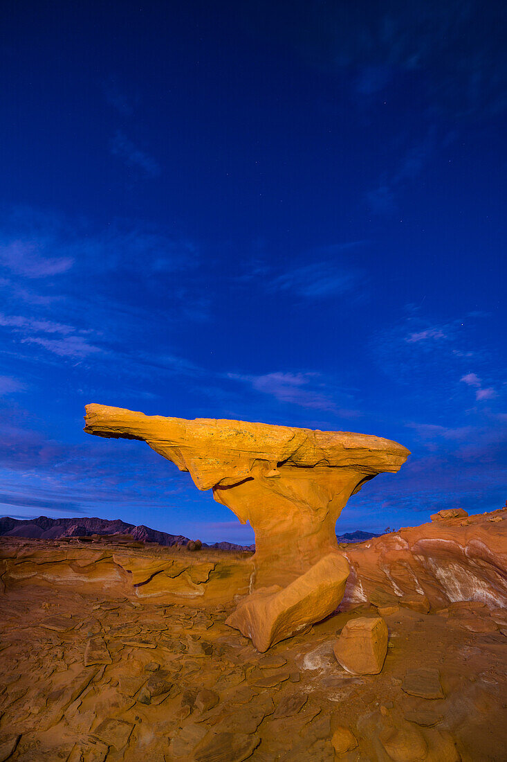 Colorful eroded Aztec sandstone formation at evening twilight in Little Finland, Gold Butte National Monument, Nevada. Overhead is the constellation Cassiopeia.