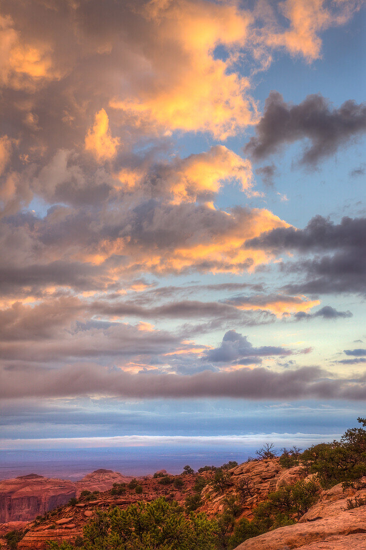 Colorful clouds at sunrise over Hunt's Mesa in the Monument Navajo Valley Tribal Park in Arizona.