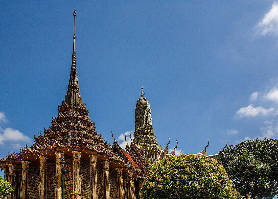 Spires of Phra Mondhop & the Royal Pantheon by the Temple of the Emerald Buddha at the Grand Palace complex in Bangkok, Thailand.