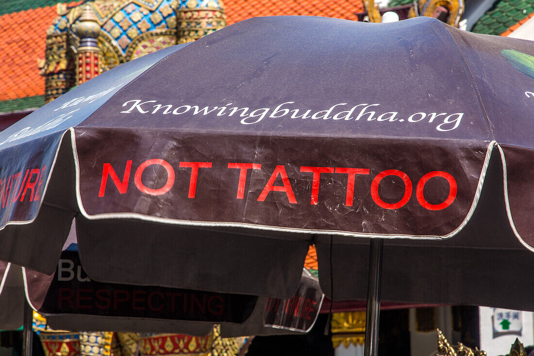 An umbrella with a message by the Chao Mae Kuan Im shrine at the Grand Palace complex in Bangkok, Thailand.