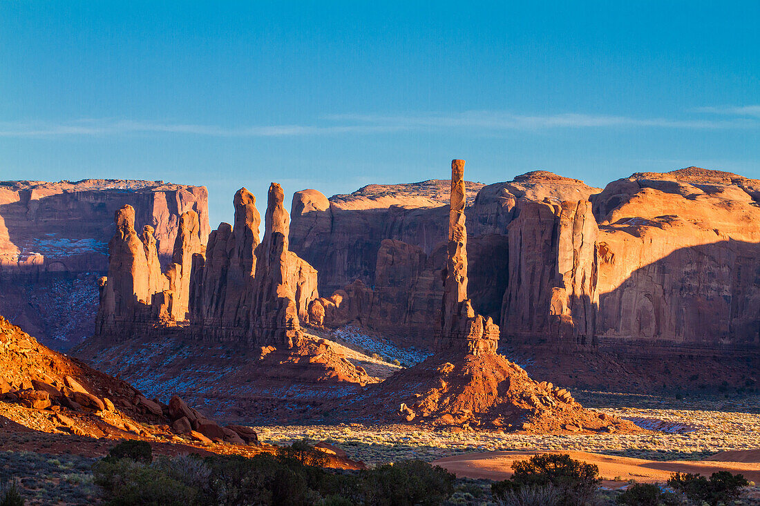 The Totem Pole and the Yei Bi Chei at sunset in the Monument Valley Navajo Tribal Park in Arizona.