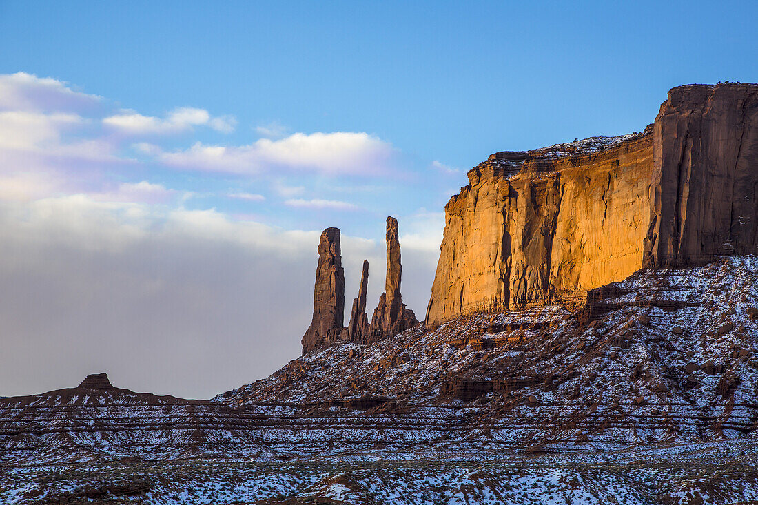 The Three Sisters, sandstone monoliths at the edge of Mitchell Mesa in the Monument Valley Navajo Tribal Park in Arizona.