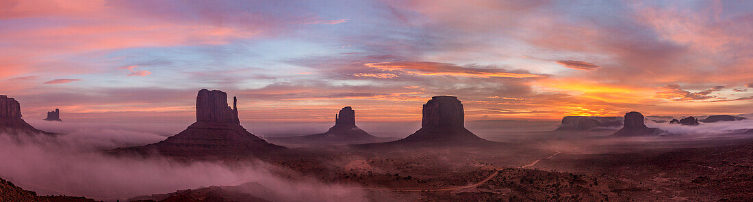 Colorful sunrise with ground fog in the Monument Valley Navajo Tribal Park in Arizona.