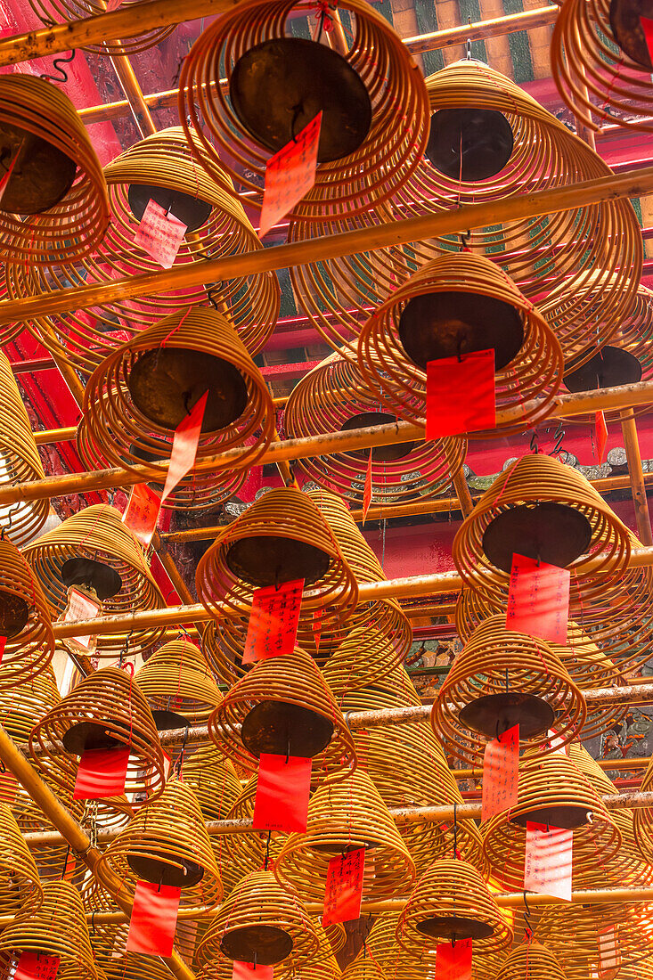 Burning incense coils send prayers to heaven in the Man Mo Temple, a Buddhist temple in Hong Kong, China.