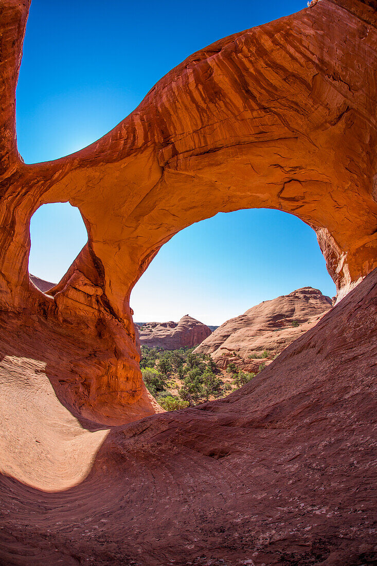 Spiderweb Arch, a large natural double arch in the Monument Valley Navajo Tribal Park in Arizona.