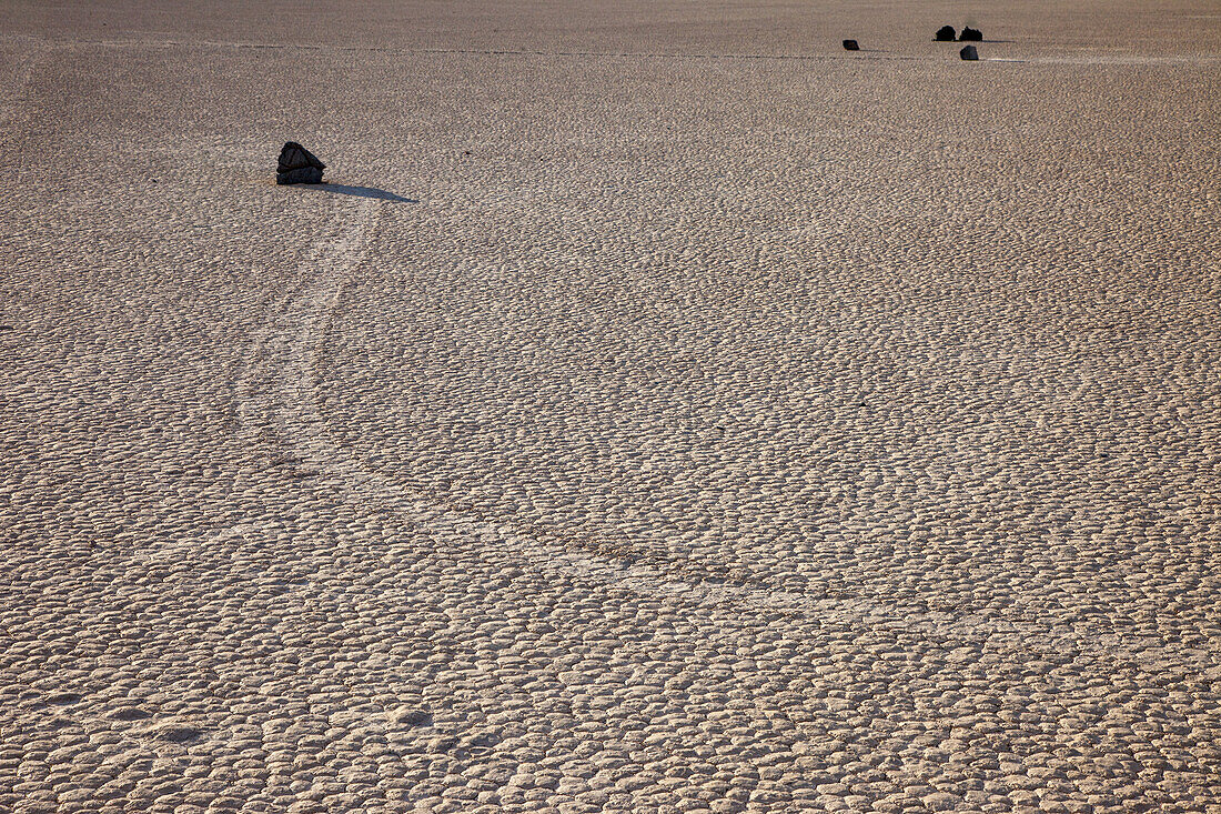 Sailing stone & track on the Racetrack Playa in Death Valley National Park in the Mojave Desert, California.