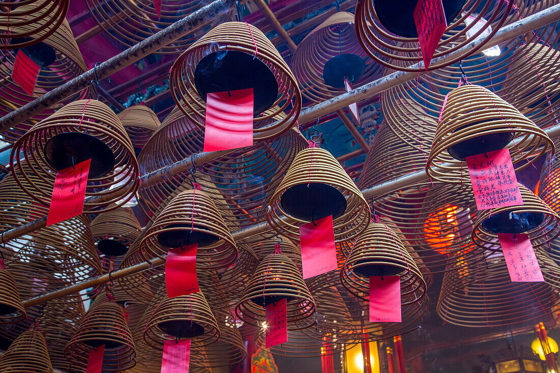 Burning incense coils send prayers to heaven in the Man Mo Temple, a Buddhist temple in Hong Kong, China.