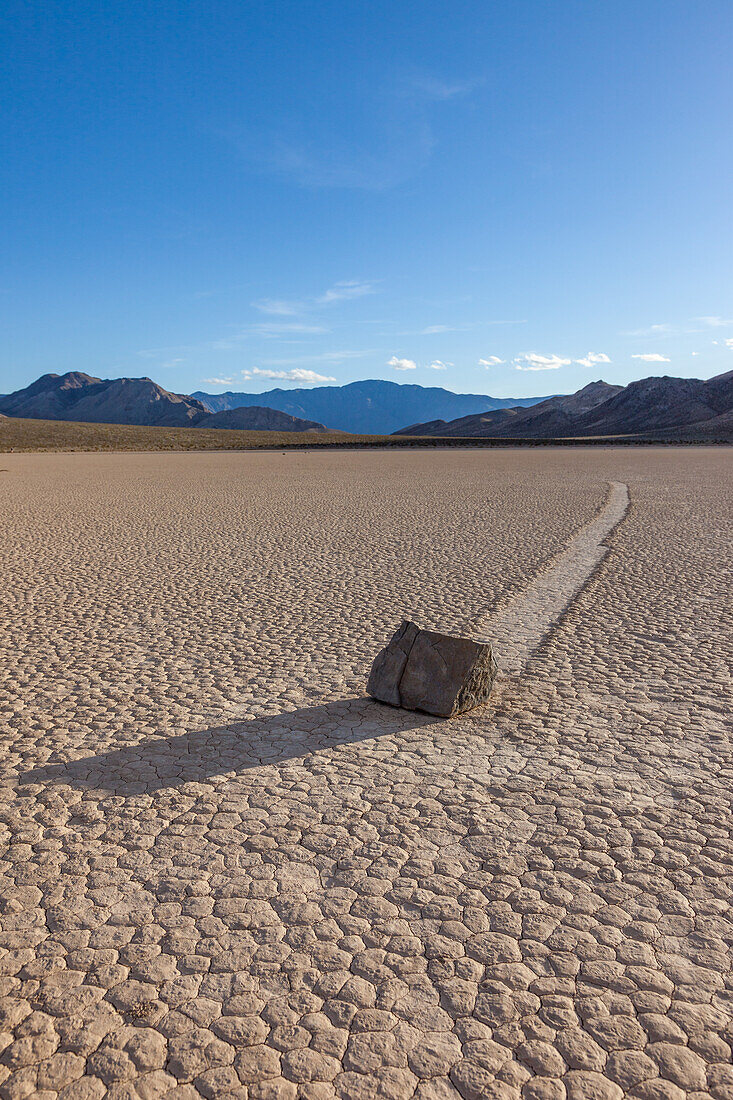 Sailing stone & track on the Racetrack Playa in Death Valley National Park in the Mojave Desert, California.