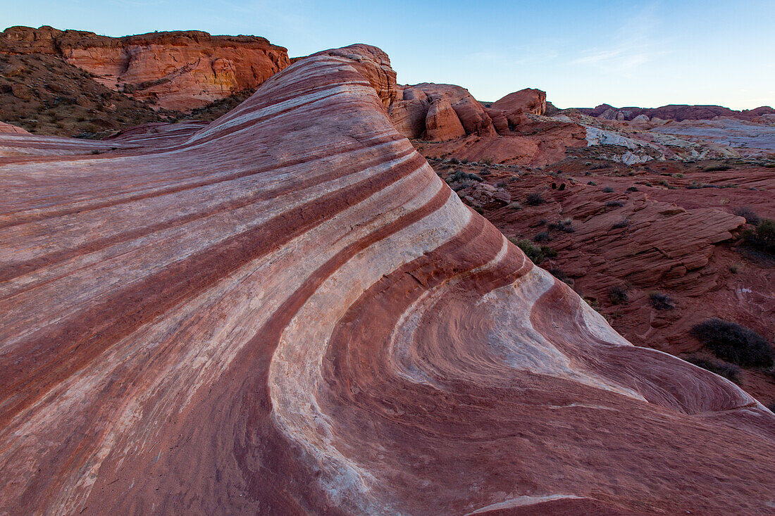 The Fire Wave, a red & white striped Aztec sandstone formation in pastel light after sunset in Valley of Fire State Park, Nevada.
