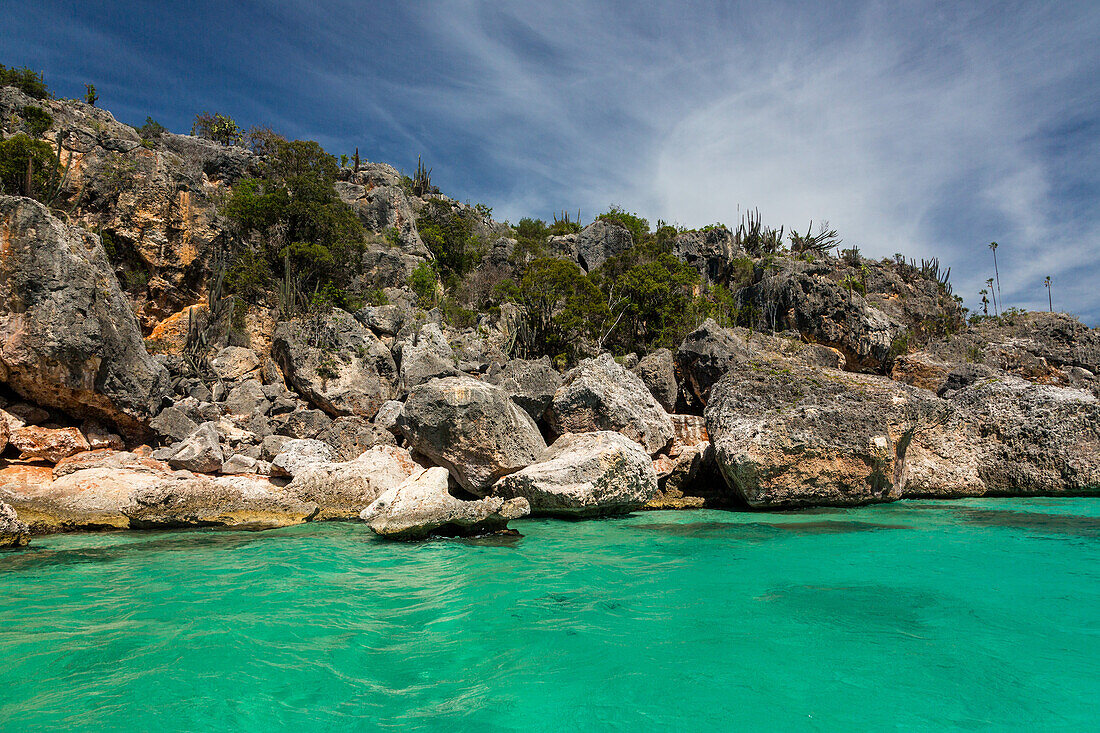 Crystal clear water in the Caribbean Sea in the Bay of Eagles, Jaragua National Park, Dominican Republic. Desert-like climate with cactus and thorn scrub vegetation.