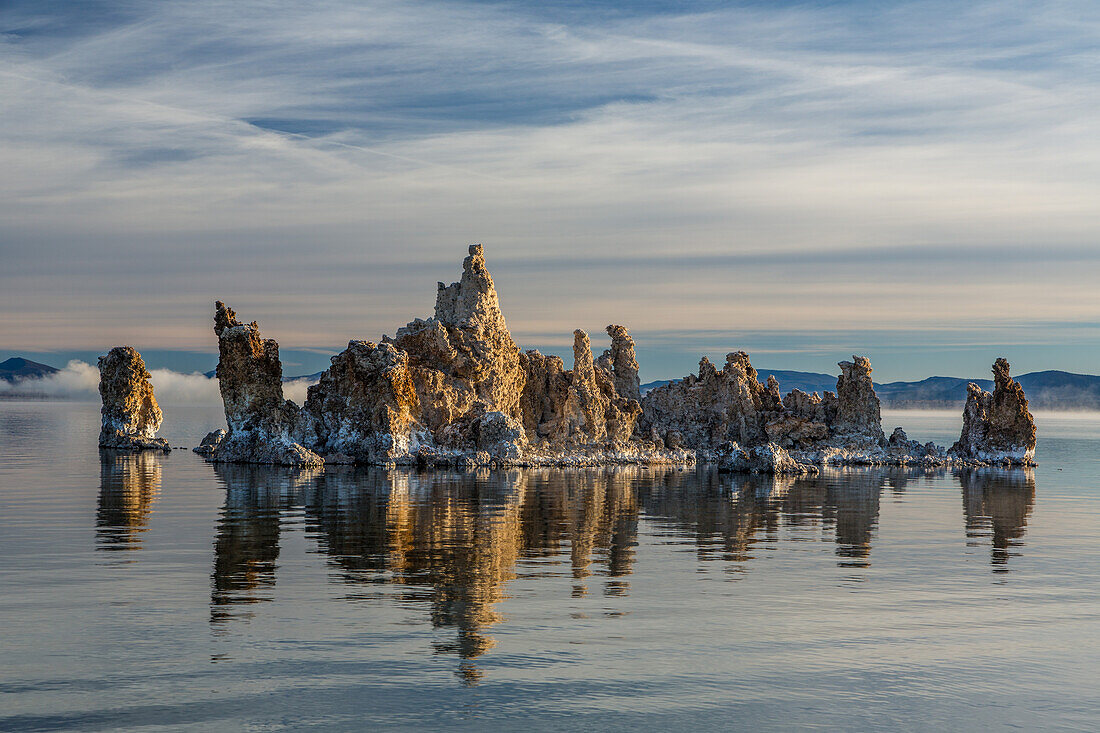 Tufa formations in Mono Lake in California at sunrise with the Eastern Sierra Mountains in the background.