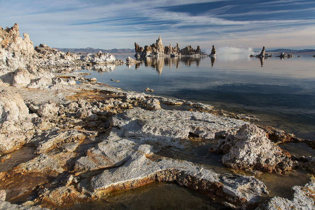Tufa rock formations with fog behind in Mono Lake in California.