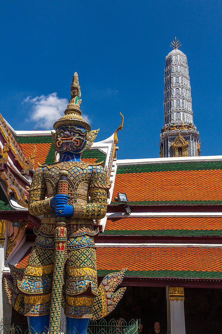 A yaksha guardian statue at the Temple of the Emerald Buddha complex in the Grand Palace grounds in Bangkok, Thailand. A yaksha or yak is a giant guardian spirit in Thai lore. Wirunhok is this guardian's name.