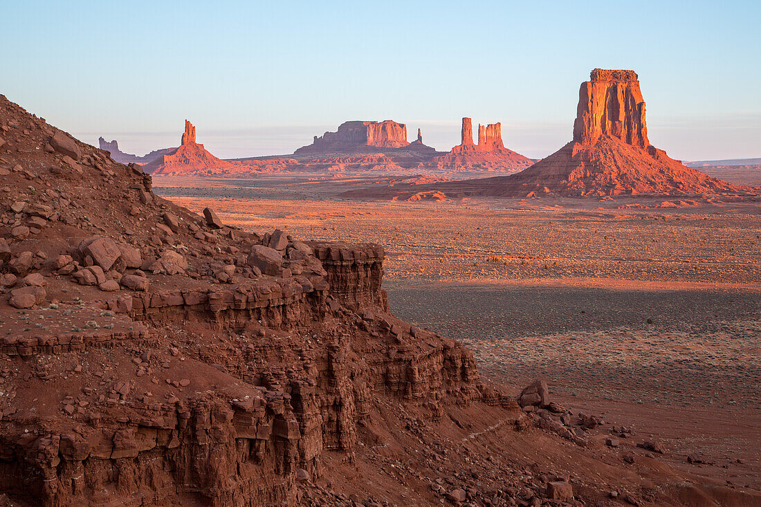 North Window view of the Utah monuments at first light in the Monument Valley Navajo Tribal Park in Arizona. L-R: Elephant Butte (foreground), Setting Hen, Big Indian Chief, Brigham's Tomb, King on the Throne, Castle Butte, Bear and Rabbit, Stagecoach, East Mitten Butte.