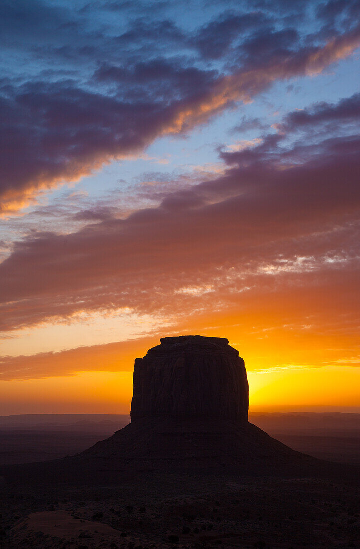 Colorful sunrise over Merrick Butte at dawn in the Monument Valley Navajo Tribal Park in Arizona.