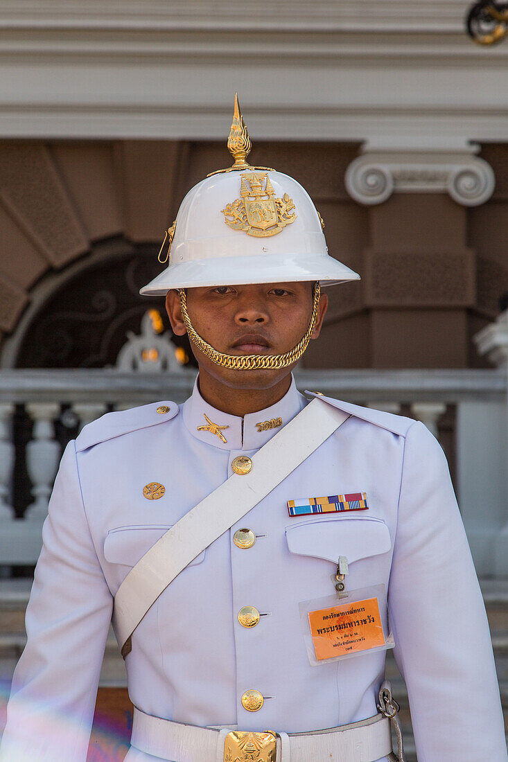 A Thai soldier in ceremonial uniform on duty at the Grand Palace complex in Bangkok, Thailand.