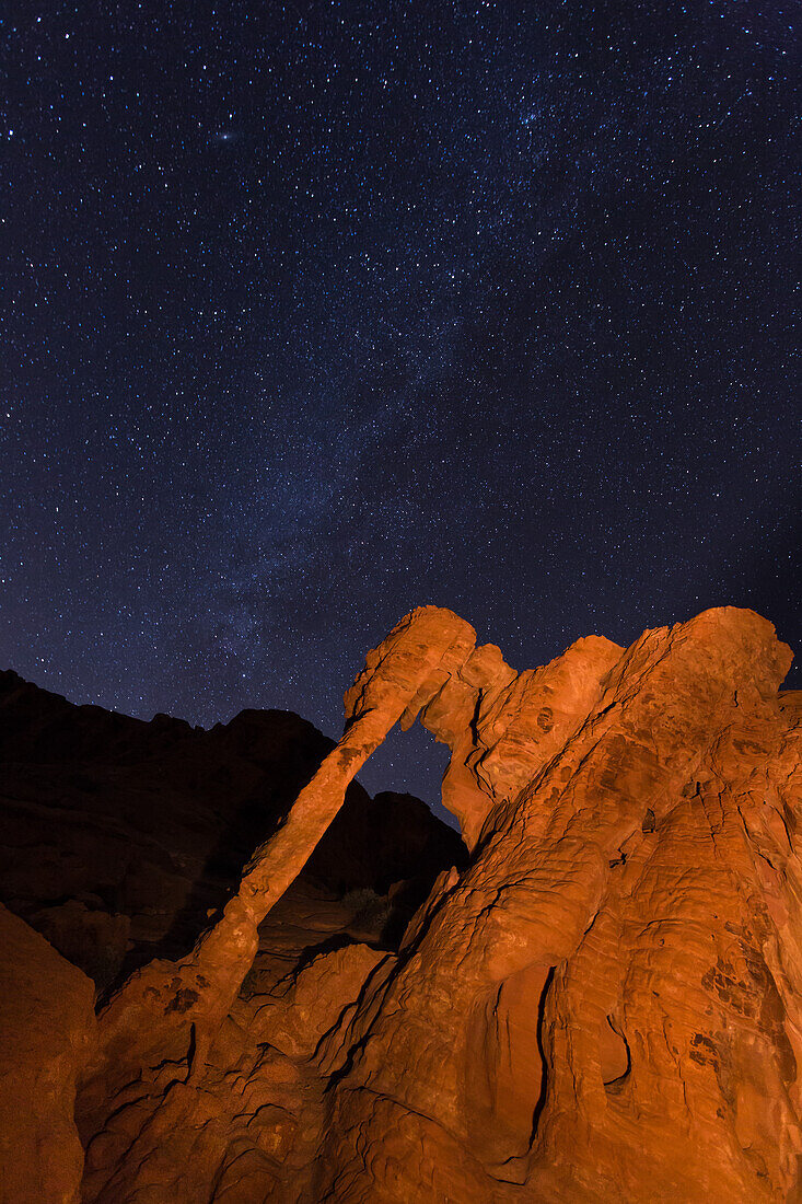 Milky Way over Elephant Rock, a natural arch in the eroded Aztec sandstone at night in Valley of Fire State Park in Nevada.