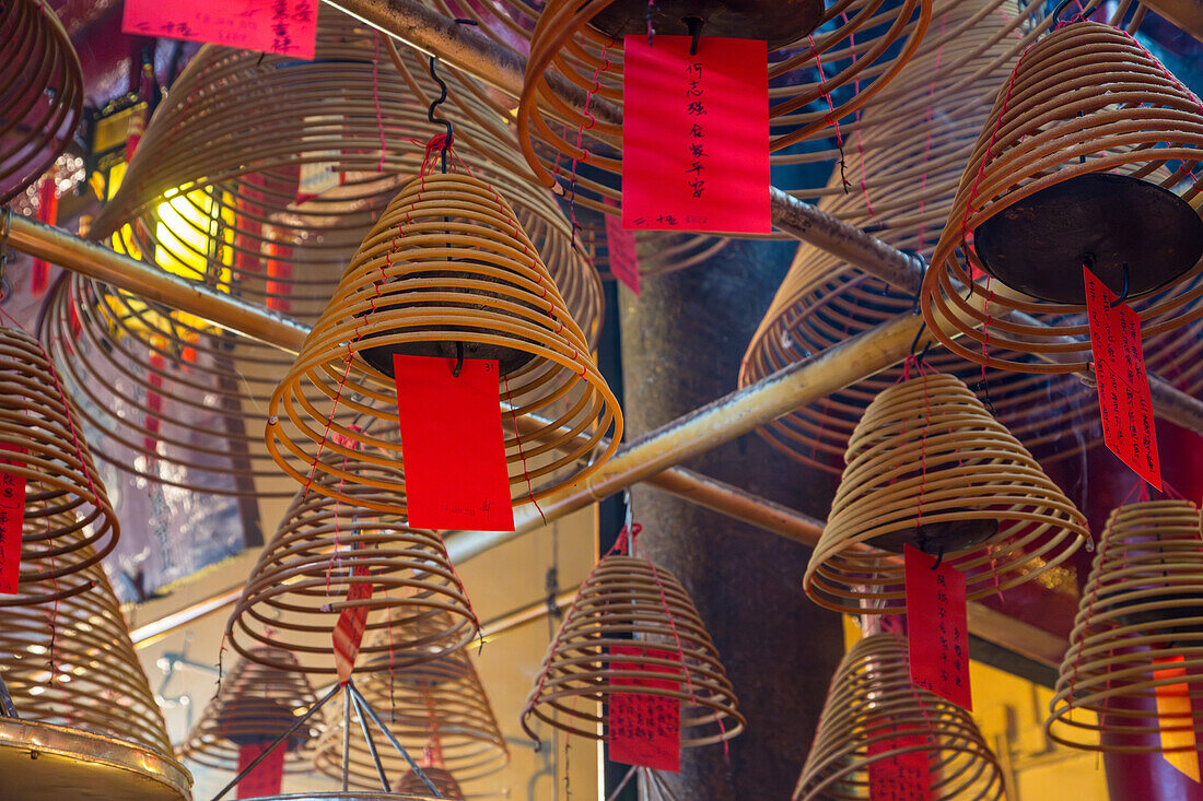 Burning incense coils send prayers to heaven in the Man Mo Temple, a Buddhist temple in Hong Kong, China.