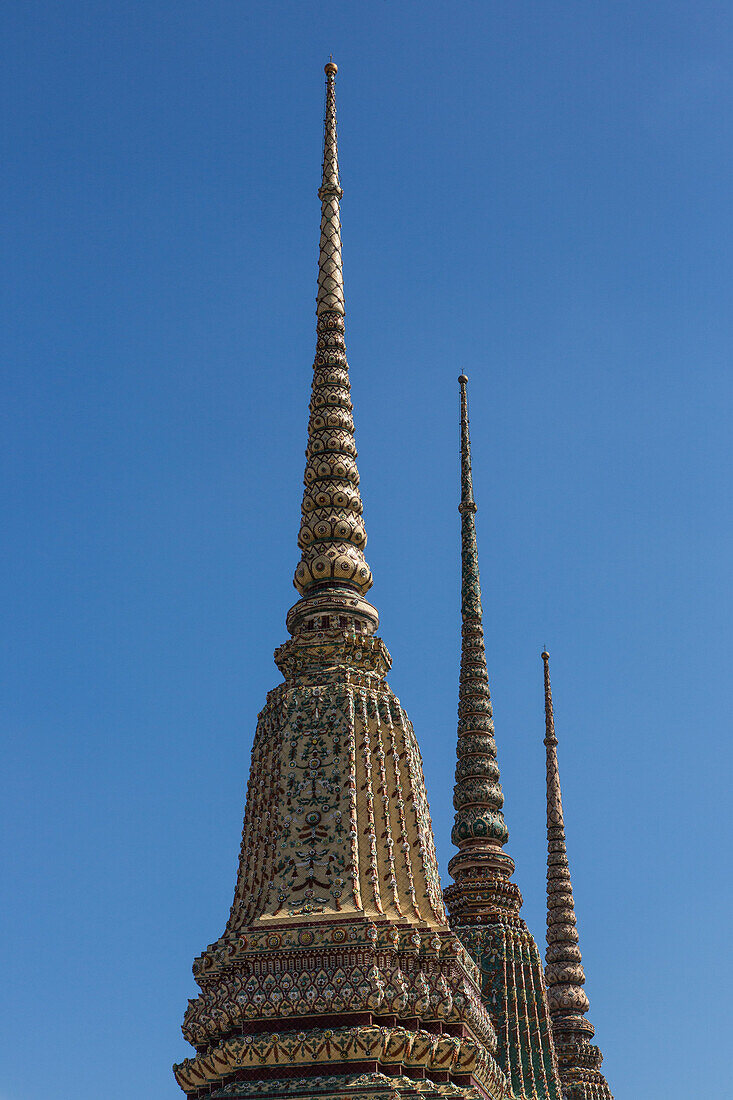 Spires of Phra Chedi Rai in the Wat Pho Buddhist temple complex in Bangkok, Thailand. They monuments built by King Rama III to hold the ashes of the royal family