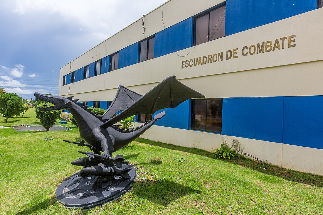 A dragon statue carrying rockets and bombs, the mascot of the combat squadron at San Isidro Air Base, Dominican Republic.