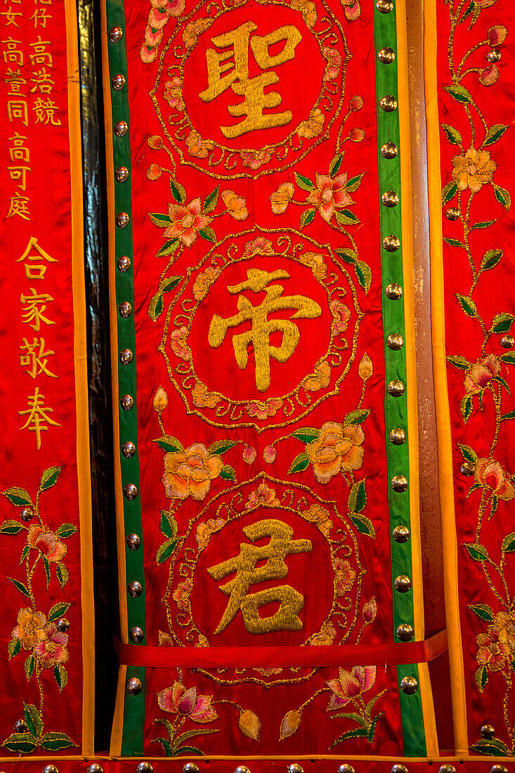 Embroidered red silk panels in the Man Mo Buddhist Temple in Hong Kong, China.