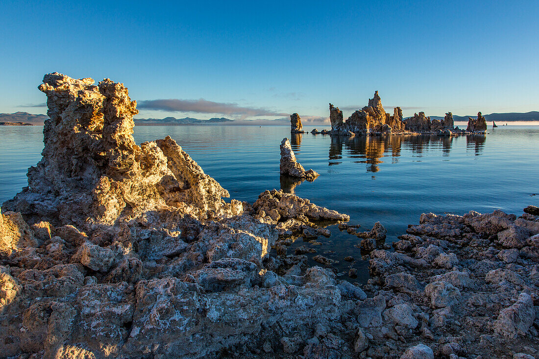 Tufa formations in Mono Lake in California at sunrise with fog in the background.