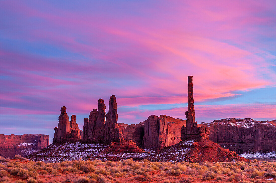 The Totem Pole and the Yei Bi Chei at sunset in the Monument Valley Navajo Tribal Park in Arizona.