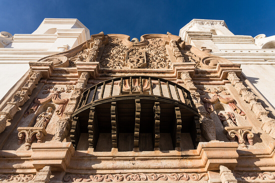 Detail of a wooden balcony and decorative designs on the Mission San Xavier del Bac, Tucson Arizona.