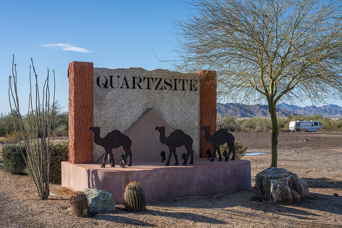 The sign at the city limits of Quartzsite, Arizona, with the Dome Rock Mountains behind.