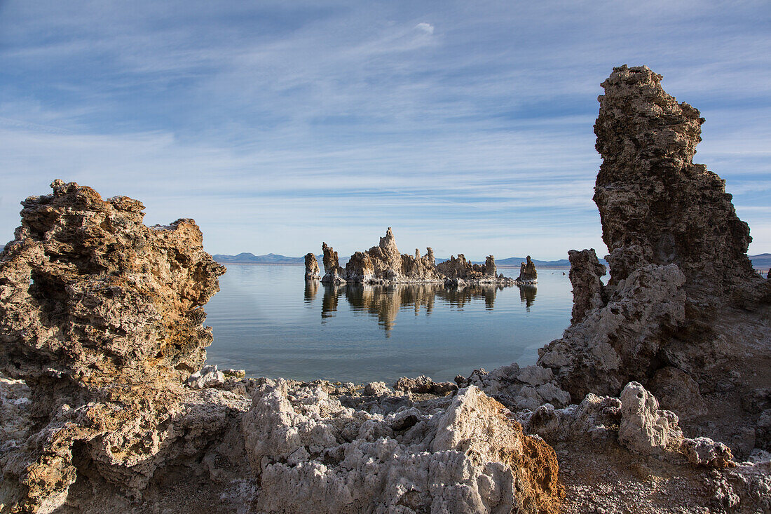 Tufa rock formations reflected in Mono Lake in California.