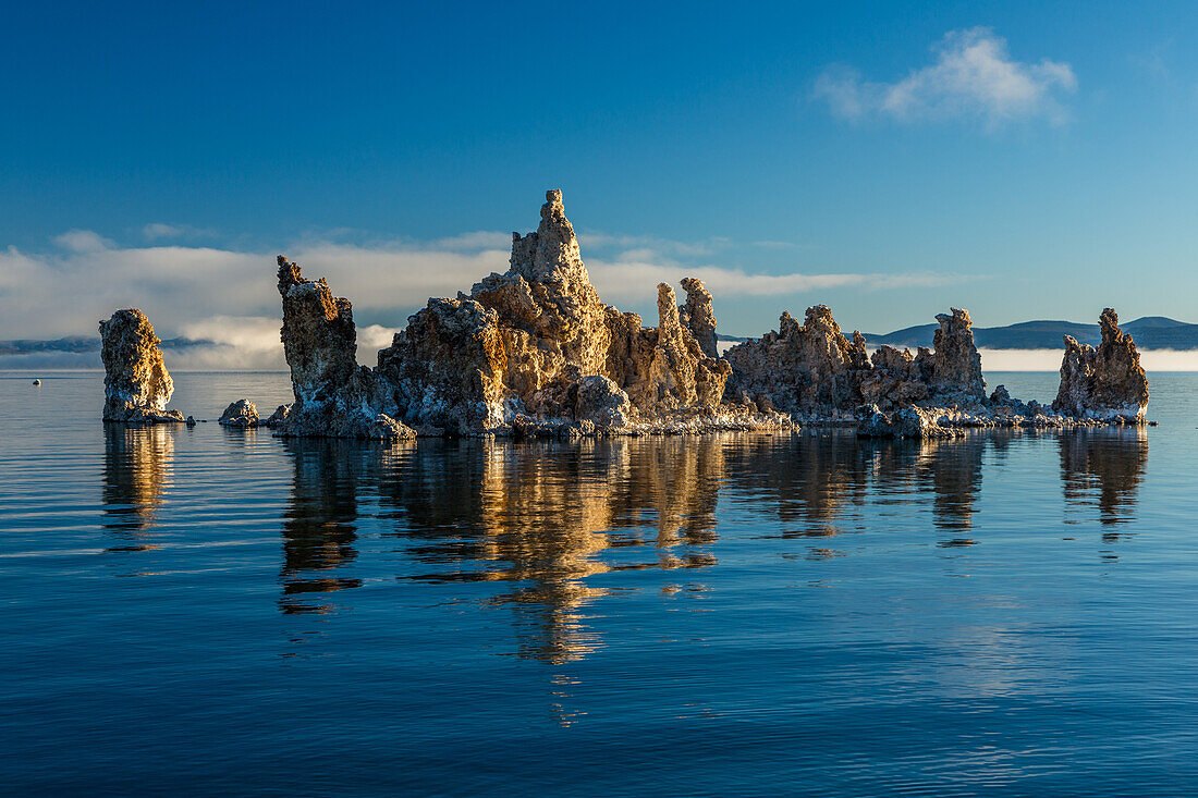 Tufa formations in Mono Lake in California at sunrise with fog in the background.