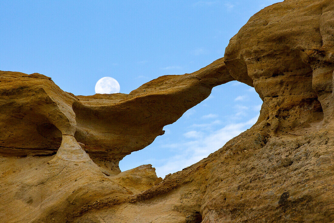 Moon and Graceful Arch in a remote desert area near Aztec in northwest New Mexico.